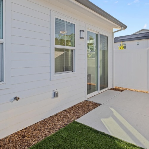 enclosed patio with green turf